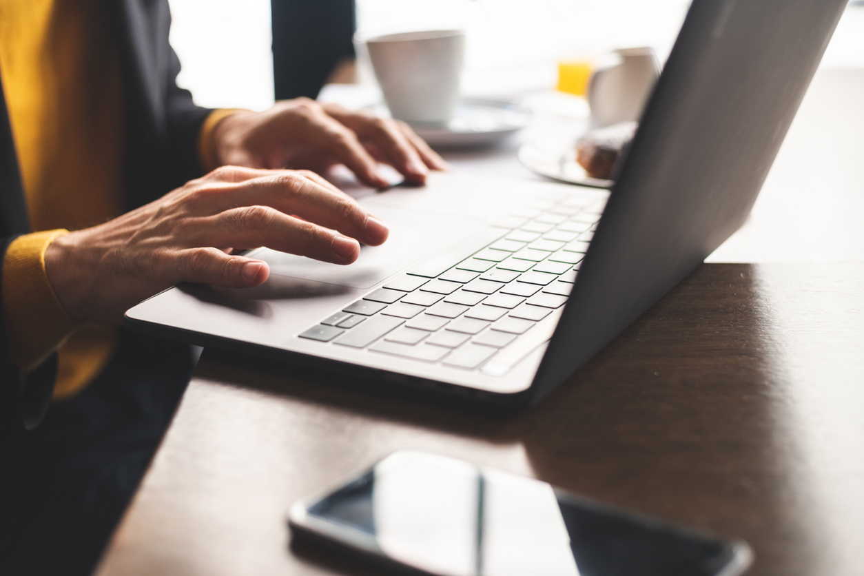 Close up of hands using laptop
